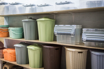 Plastic products containers boxes baskets for storage and organization of space and interior on the shelf in the store. Sale of household goods. Stock