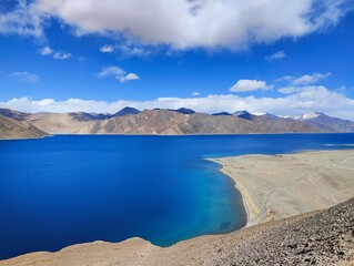 Blue reflective water of Pangong Lake in Ladakh India near Jammu at Indo-China border clear see through blue water on April 2022 lonely natural wonders on earth, Pangong Tso Lake in Ladakh  - obrazy, fototapety, plakaty