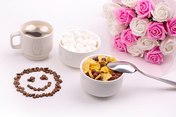 Good breakfast. Cereal with milk, coffee with marshmallows, a bouquet of roses and a smiling smile made of coffee beans