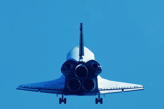 Space shuttle from behind, taking off. Elements of this image furnished by NASA