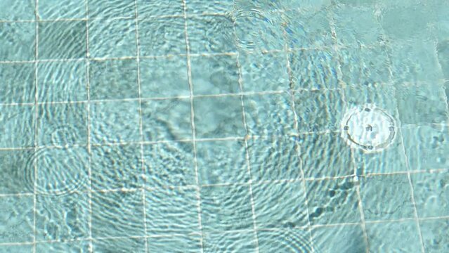 Bubble in therapeutic pool floating up to water surface, massage stream tidal for relaxing, nature hot springs in bath, moving shadow of circle shape wave on tile floor 