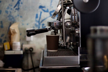 waiter preparing a coffee at the bar's coffee