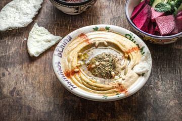 Chickpeas hummus with olive oil and smoked paprika with cucumber and radish