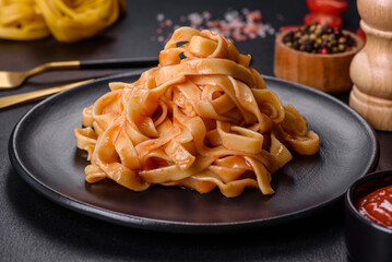 Tasty appetizing pasta tagliatelle spaghetti with tomato sauce and parmesan