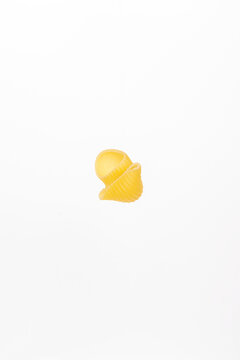One piece of pasta on a white background.