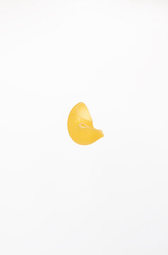 One piece of pasta on a white background.