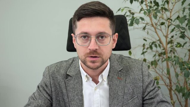 Handsome businessman office worker in glasses having video call with leader company meeting online listening to speaker agreeing nodding head looking to camera web cam view. Internet communication.