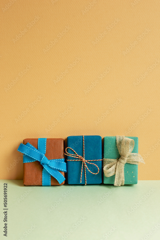 Wall mural gift boxes on table. orange background