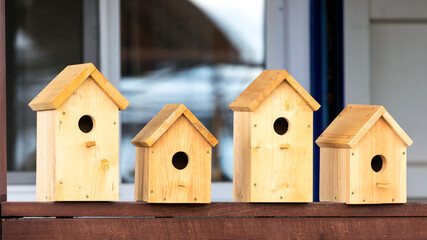 Obraz na płótnie Canvas Four wooden birdhouses on sale