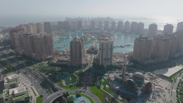 Doha, Qatar. Push in drone shot over tall residential buildings at the marina in the Pearl.