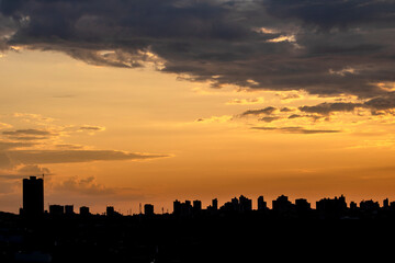 Fototapeta na wymiar Silhouette of cityscaper buildings during a sunset in Brazil