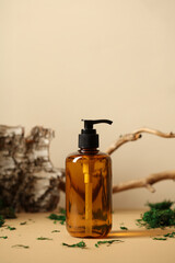 Amber glass pump shampoo bottle mockup. SPA natural organic cosmetics packaging design. Tree...