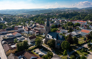 Fototapeta na wymiar Drone view of the city of Pregarten. Bird's eye view of the old church, the clock tower on the square in Austria, Tyrol