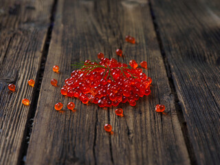 red fish salmon caviar served on the vintage wooden desk with salt lemon and bread