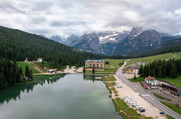 Fototapeta na wymiar Panorama drone view of Lago di Misurina, reflection of the mountain in the lake, flying through the fog in the Dolomites in Italy