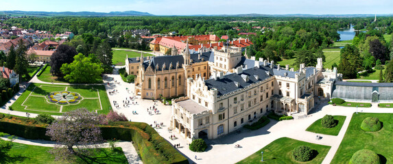 Lednice Chateau extra wide panorama aerial photography with garden and park on summer day. Lednice - Valtice landscape, Czech South Moravia region. World Heritage Site. - 505708595