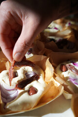 Dough balls, making focaccia bread with onion and olives. Chef hand make focaccia bread