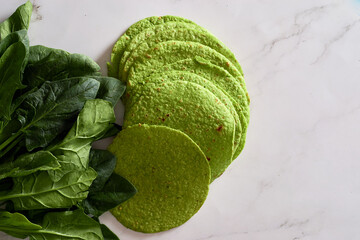 Green tortillas with spinach, round empty tortilla flatbreads for wraps, trendy mexican food,...