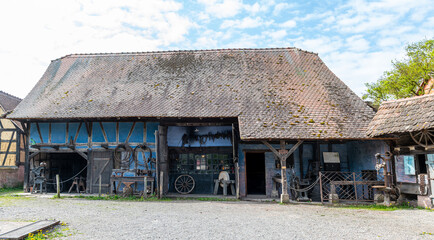 Fototapeta na wymiar Traditional blacksmith in old alsatian house in the Ecomuseum Alsace in city of Mulhouse, Alsace, France