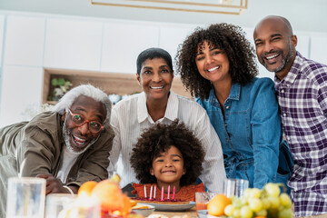 Happy family celebrating birthday of girl at home