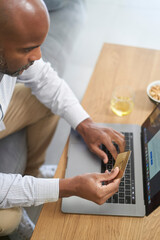 Fototapeta na wymiar Man using laptop and credit card