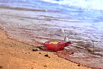 Wine glass with a cocktail by the sea.