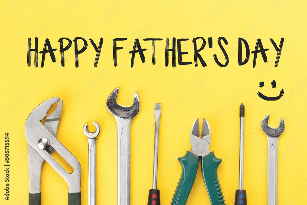 Wall mural Work tools on bright yellow background with inscription happy father's day. Happy fathers day concept or greeting card. Top view, flat lay