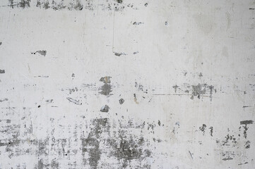 grunge background: white shabby wall with cracks and stains