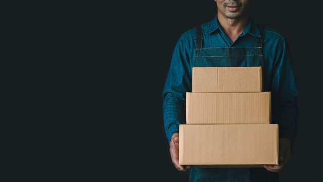 Online shopping, a young start-up small business owner raises a cardboard box at work, Small Business Entrepreneurs SME, Work With Box At Home, Online Sales, E-Commerce, Packaging.