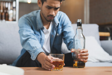 Alcoholism concept. Young man drinking alcohol too much.
