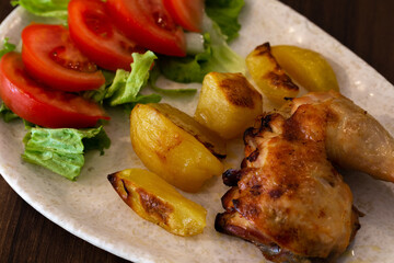 Roasted Chicken with Potatoes and a Tomato Salad, Braga, Portugal.