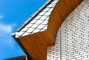 The church has a classic PVC soffit that imitates wood with a white brick facade.