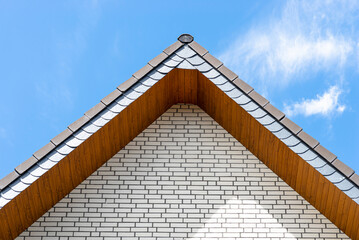 The church has a classic PVC soffit that imitates wood with a white brick facade.