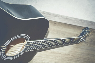 Beautiful musical instrument. The guitar lies on the floor. Beautiful guitar