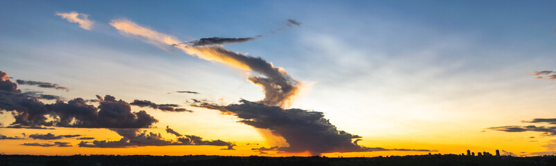 Panoramic of a beautiful sunset with amazing clouds