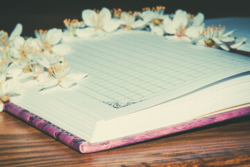 Flowers on a notebook. Spring flowers in writing. Romantic flowers