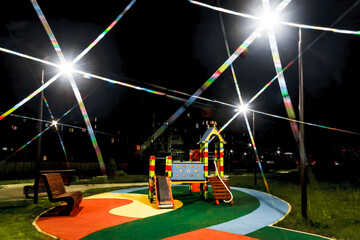 Night view playground in the yard in the light of street lights
