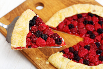 Piece of pie with red and black raspberries