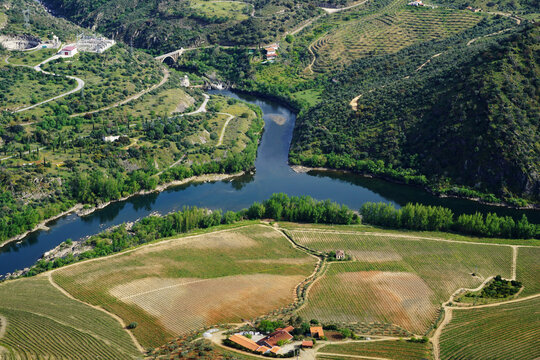 Aerial view from Penedo Durao viewpoint, typical landscape of the International Douro Park, Douro river and highlands in the north of Portugal, Spain mountains as background.
