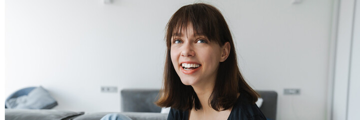 Happy young white woman holding joystick