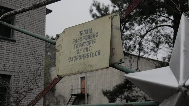 
warning sign on an abandoned part in the Chernobyl zone