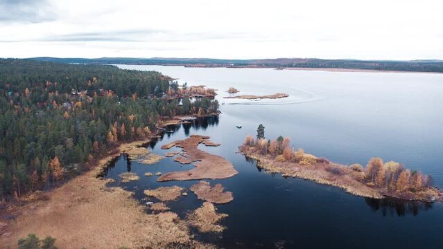 Aerial view of the lake in Kola Peninsula in Russia. Flight over the lake in arctic area during autumn
