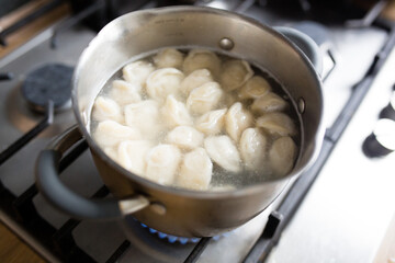 dumplings are cooked in a pan