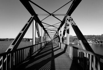 Old steel bridge over Ruhr river at “Baldeneysee“ in Essen Germany. Former railway bridge with...