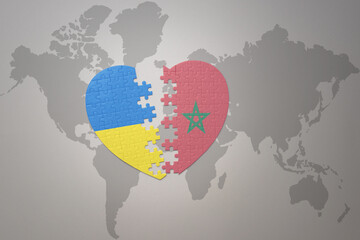 puzzle heart with the national flag of ukraine and morocco on a world map background. Concept.