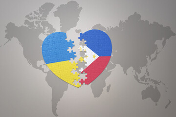 puzzle heart with the national flag of ukraine and philippines on a world map background. Concept.