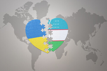 puzzle heart with the national flag of ukraine and uzbekistan on a world map background. Concept.