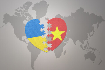 puzzle heart with the national flag of ukraine and vietnam on a world map background. Concept.