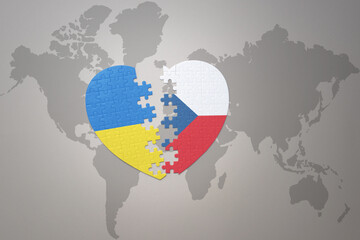 puzzle heart with the national flag of ukraine and czech republic on a world map background. Concept.