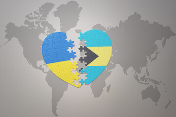 puzzle heart with the national flag of ukraine and bahamas on a world map background. Concept.
